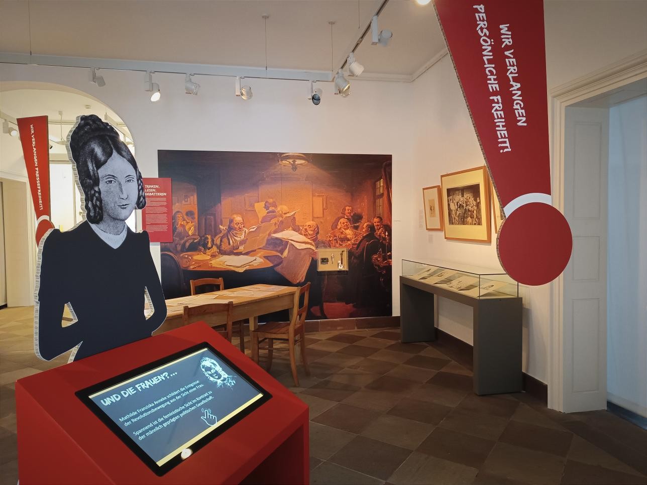 A room with exhibits in the Rastatt City Museum, with an information terminal in the foreground.